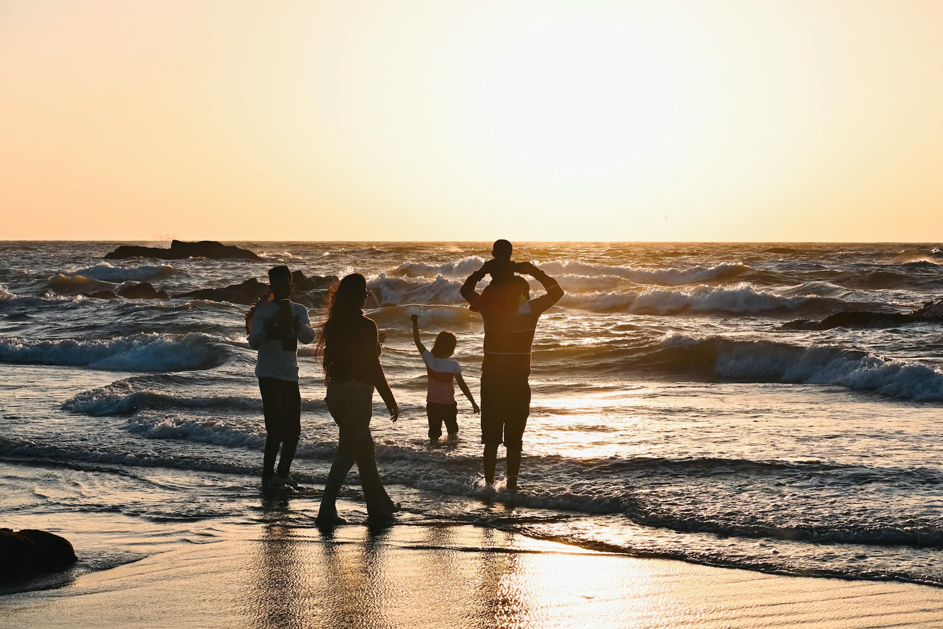 family enjoying sunset at goa beach