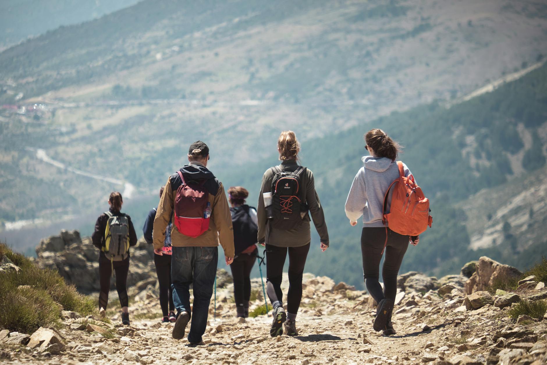 people walking on the dirt road